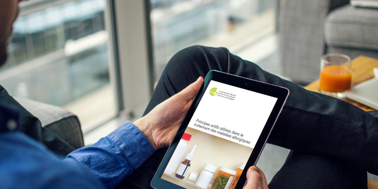 Un homme lit une brochure sur une tablette