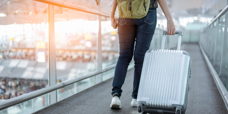 Eine Person mit einem Rollkoffer am Flughafen